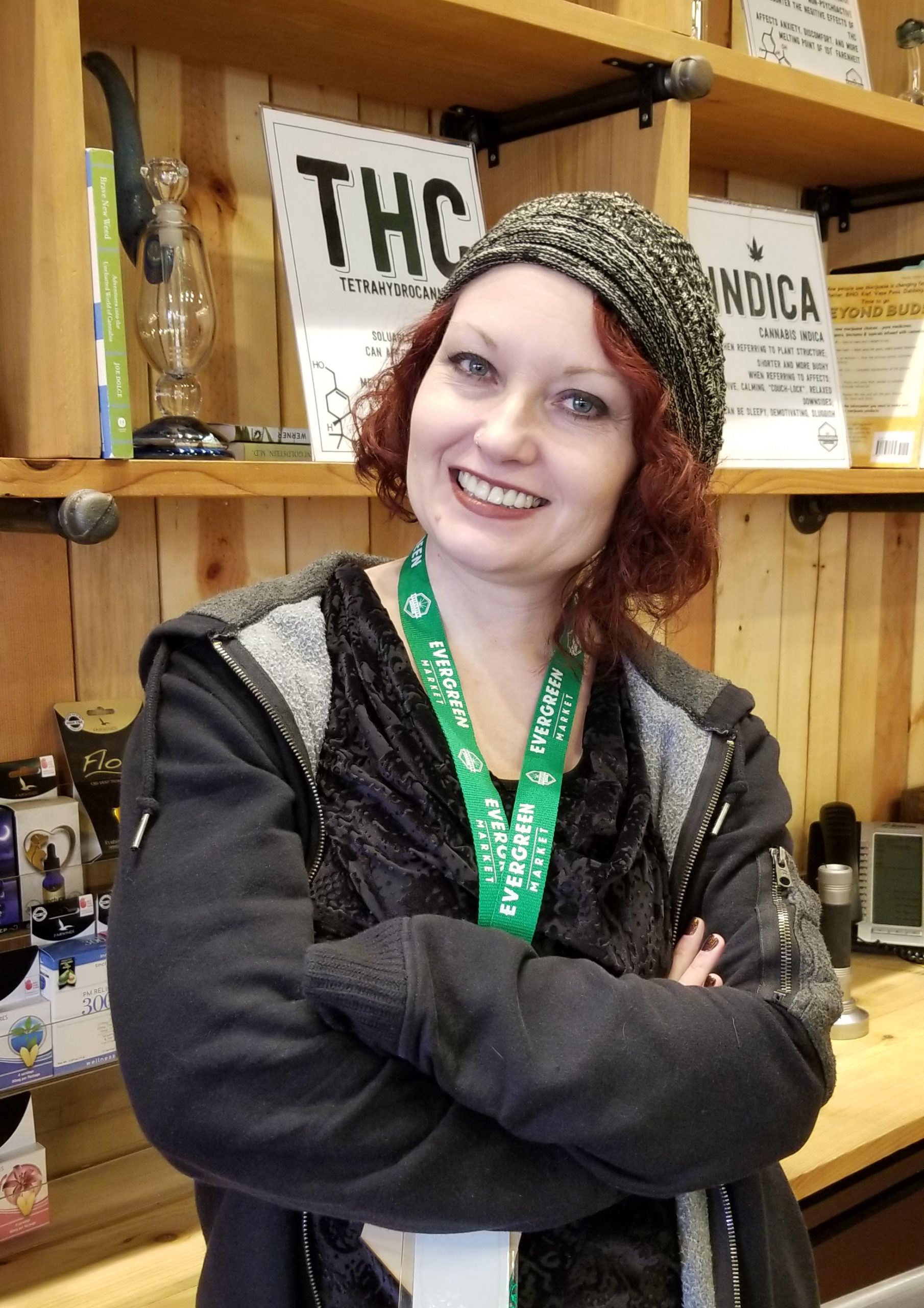 Gillian the bookkeeper who just got her MBA stands behing the knowledge bar with her bright red hair